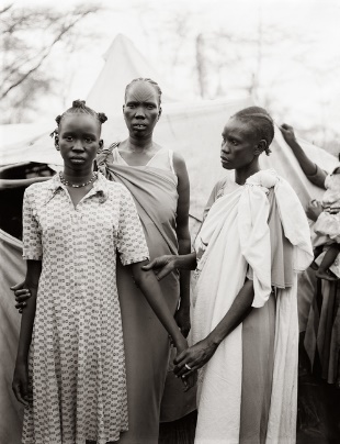 Figure 2: Fazal Sheikh’s triple portrait of Akuot Nyibol (centre) with Riak Warabek (right) and the pregnant Akuot’s daughter, Athok Duom, who is recovering from malaria, at the Sudanese refugee camp in Lokichoggio © Fazal Sheikh